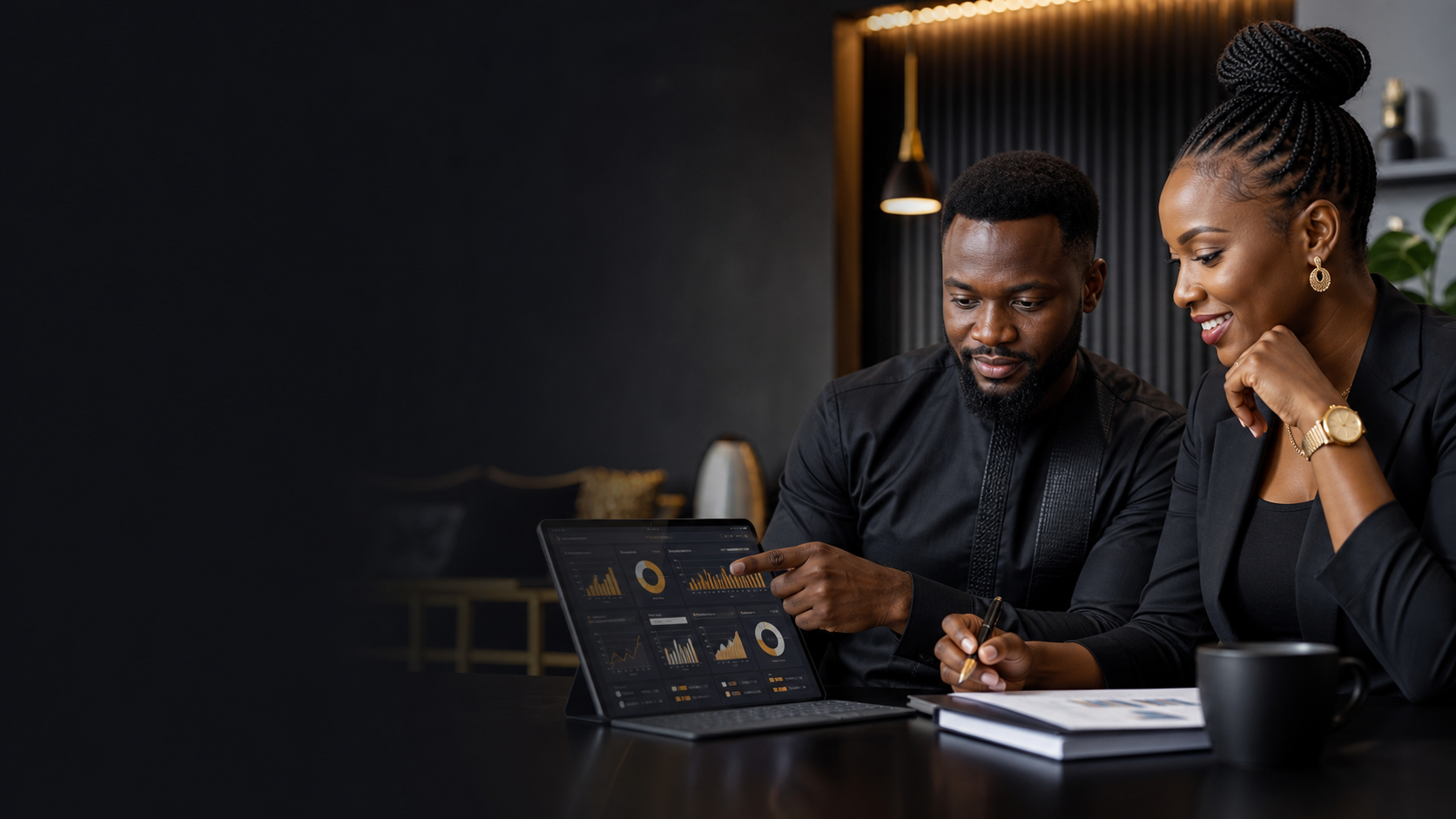 Black Nigerian business owners reviewing software dashboards